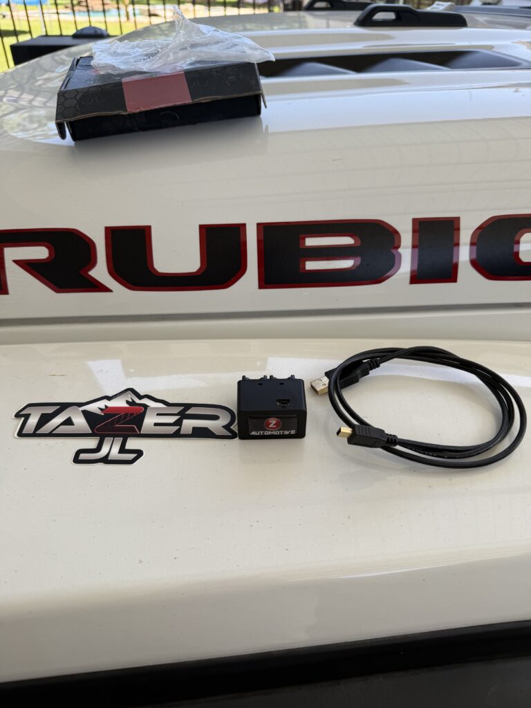Tazer JL Mini package contents — unit, USB cable, and box